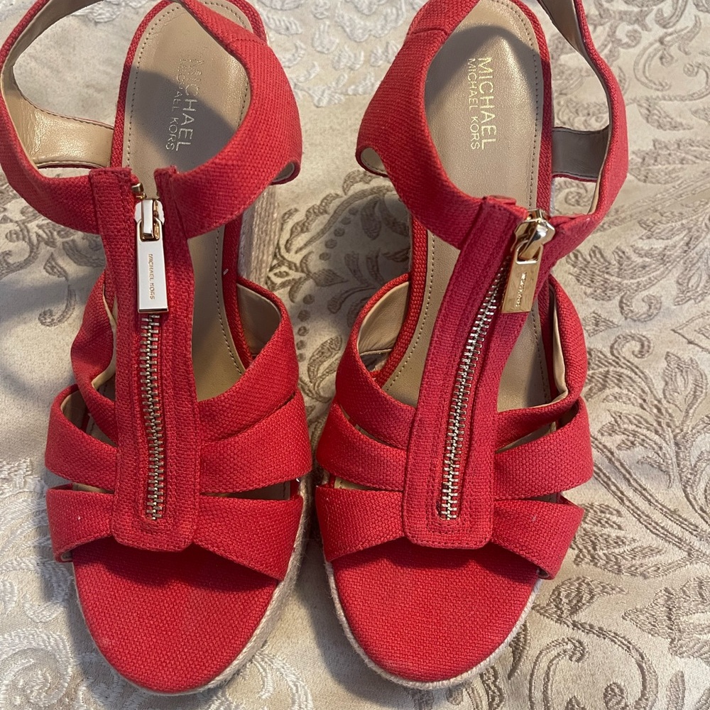 Brand new never worn size 9 women’s Michael Kors wedge sandals in red.